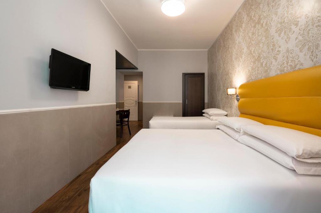 Cama ou camas em um quarto em Hotel Virgilio