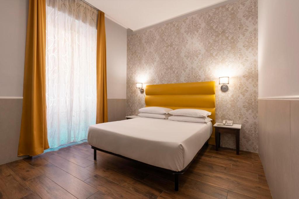 Cama ou camas em um quarto em Hotel Virgilio