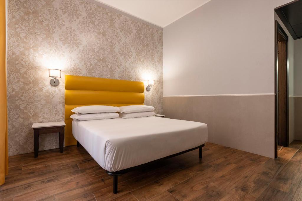 Cama ou camas em um quarto em Hotel Virgilio