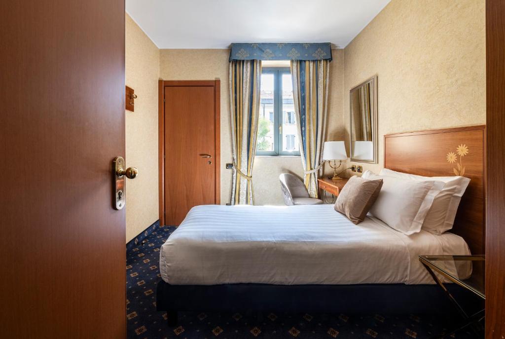 Postel nebo postele na pokoji v ubytování Boutique Hotel Dieci