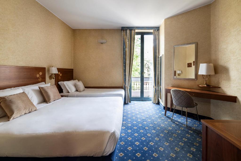 Postel nebo postele na pokoji v ubytování Boutique Hotel Dieci