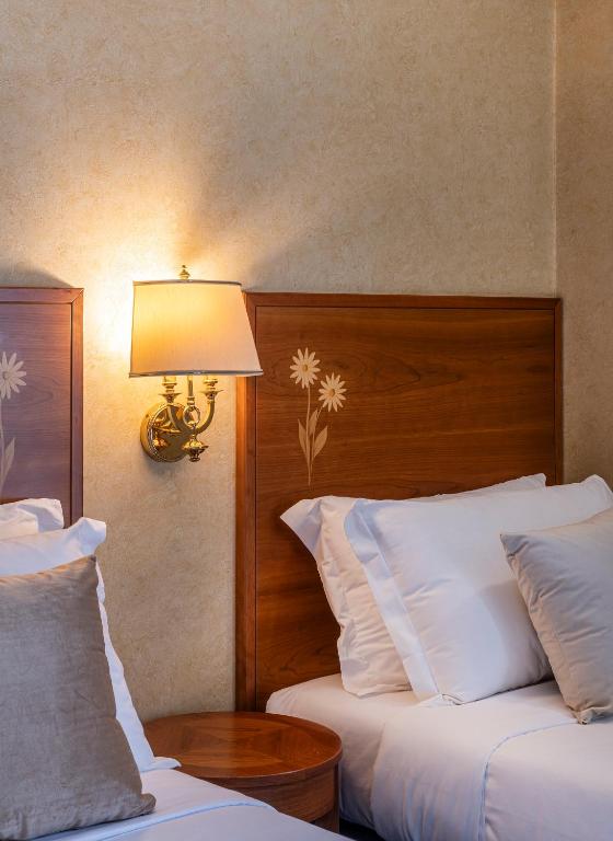 Postel nebo postele na pokoji v ubytování Boutique Hotel Dieci