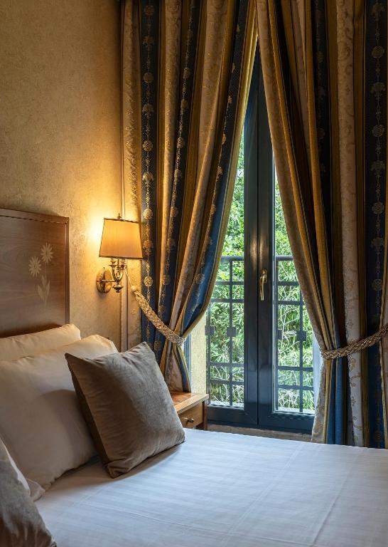 Postel nebo postele na pokoji v ubytování Boutique Hotel Dieci