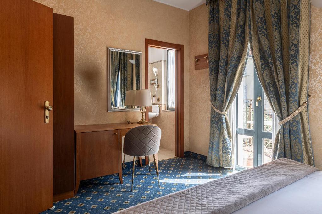 Postel nebo postele na pokoji v ubytování Boutique Hotel Dieci