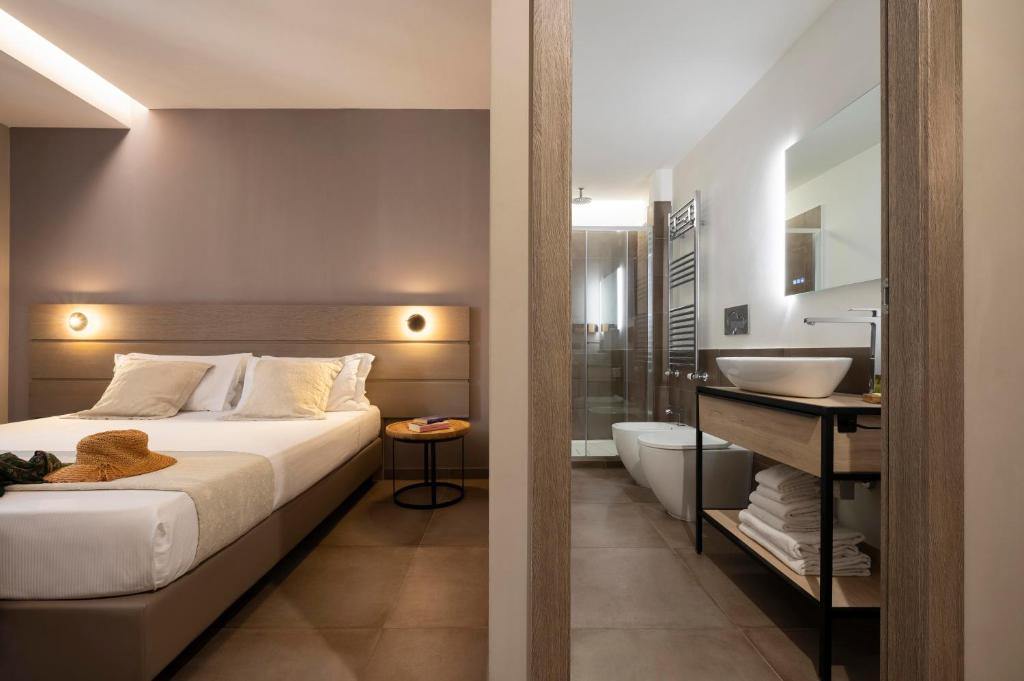 a bedroom with a large bed and a bathroom at The Point Suites Rome - Guest House in Rome