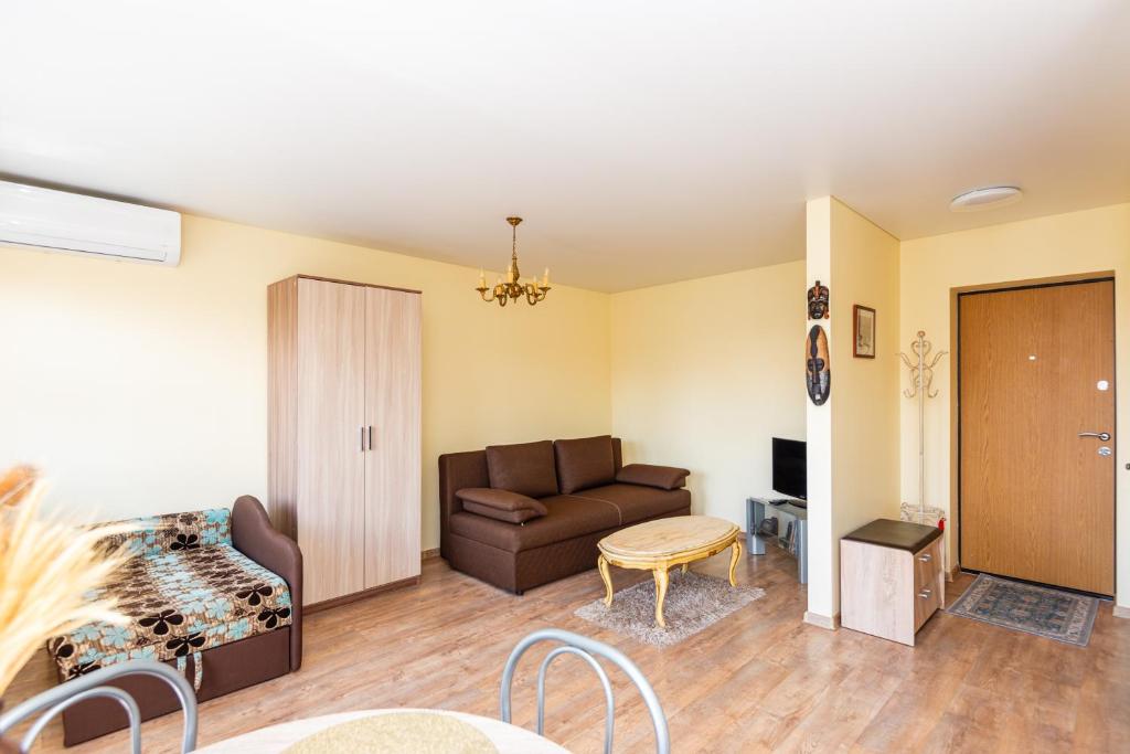 a living room with a couch and a table at Golden Dune Apartment in Klaipėda