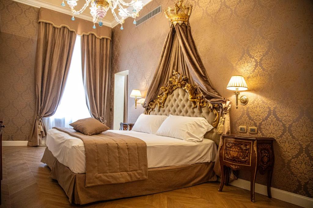 Postel nebo postele na pokoji v ubytování Palazzo dei Mori