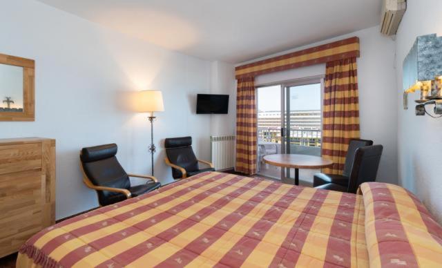 Rúm í herbergi á Hotel Apartamentos Bajondillo