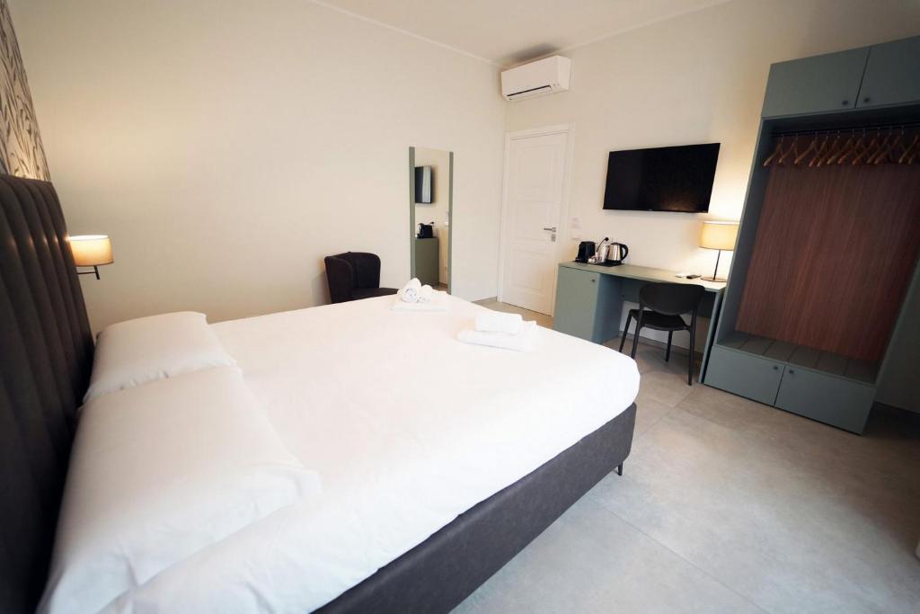 Postel nebo postele na pokoji v ubytování Annunziatella Suite & Rooms