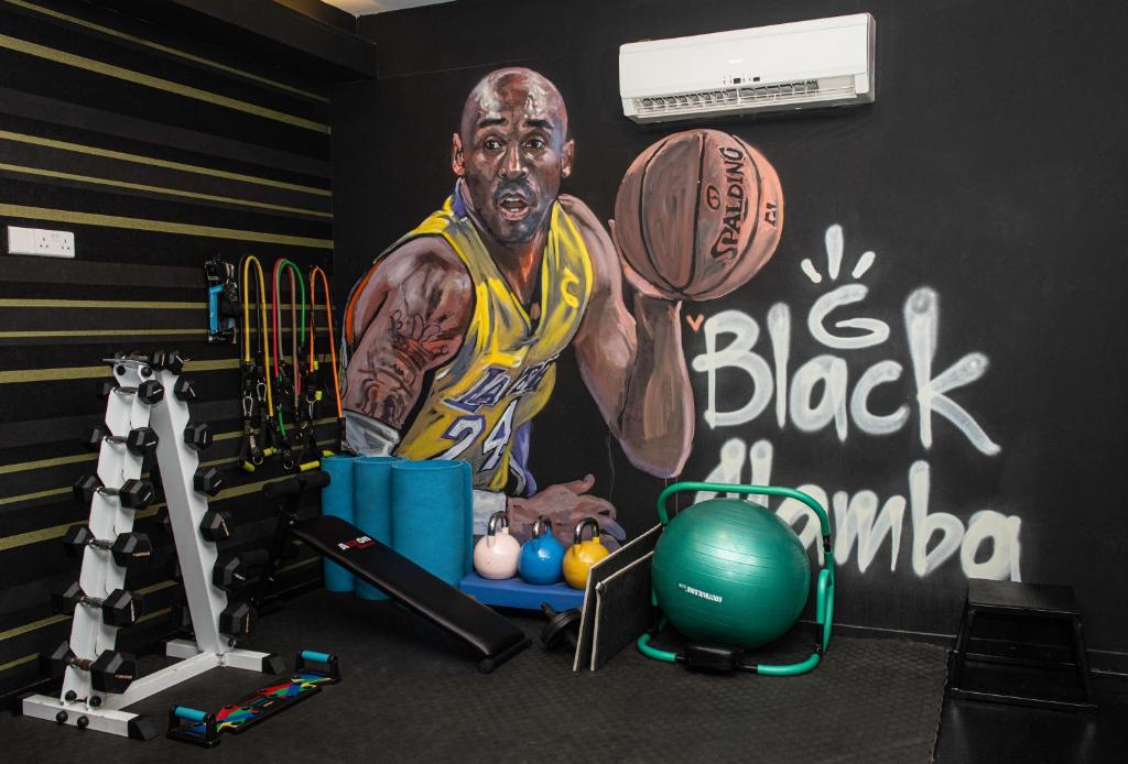 a gym with a basketball player painted on the wall at Rise Urban Art Hotel in Larnaca