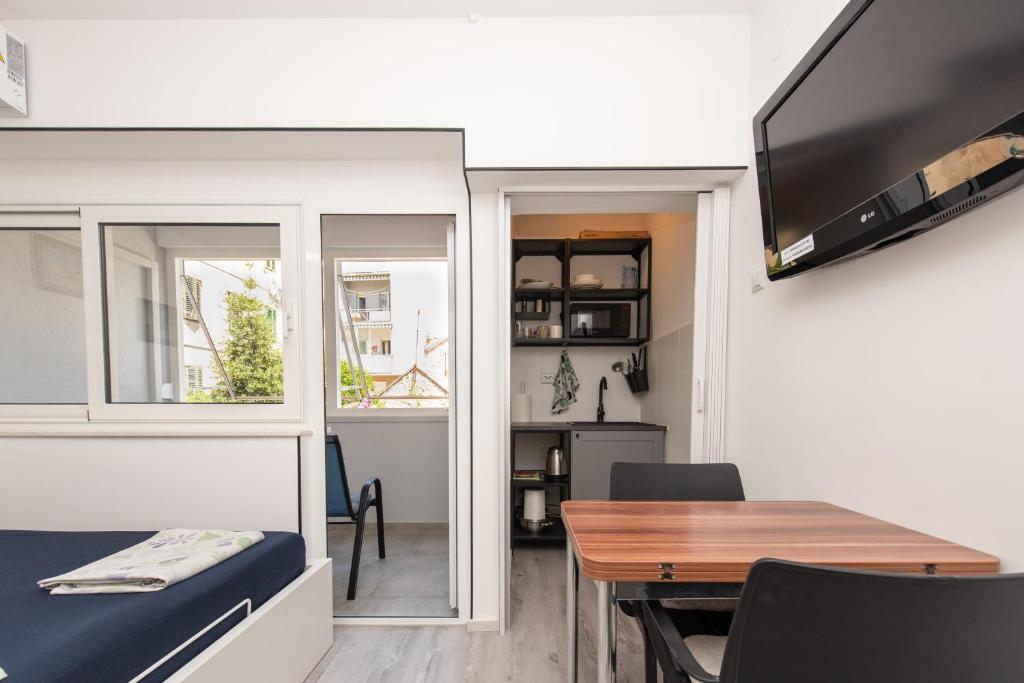 Televízia a/alebo spoločenská miestnosť v ubytovaní Laghanini Apartments