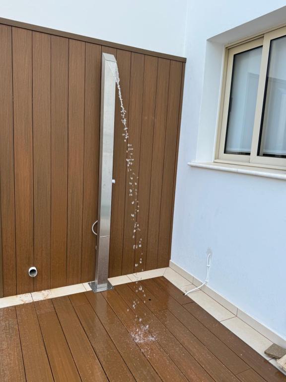 a room with a door with water coming out of it at Paez Villa in Protaras