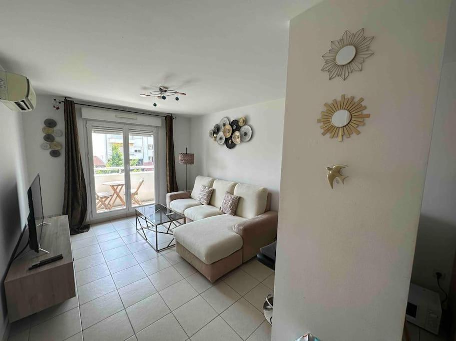 un salon avec un canapé et une télévision dans l'établissement Beau T2 Climatisé, 1min à pied de la promenade des anglais et plage, à Nice