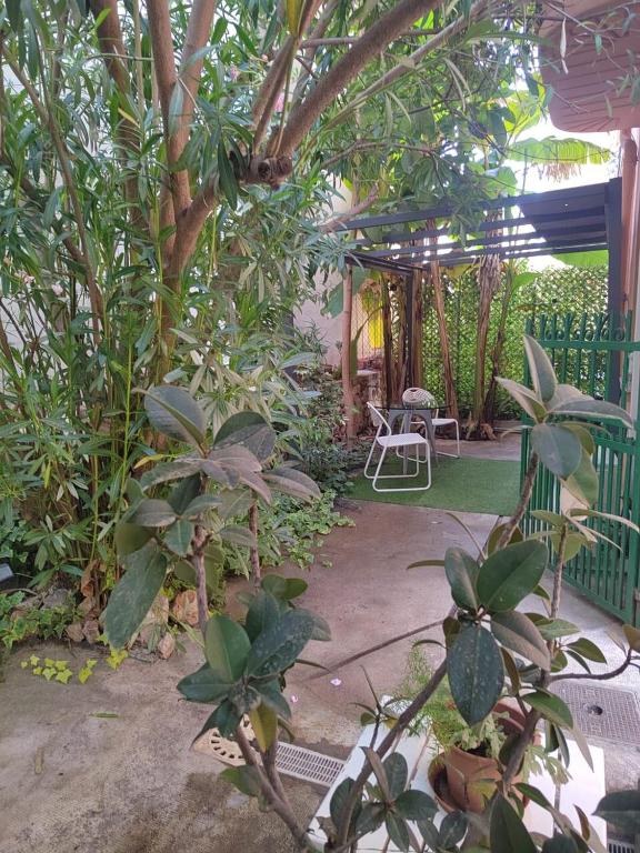 a garden with a table and chairs and trees at Monaco Studio #3 with private patio in Beausoleil
