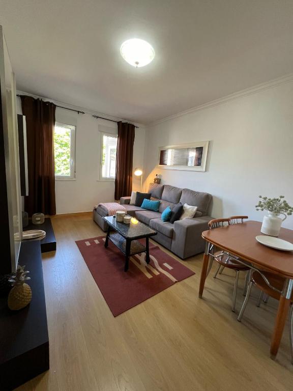 a living room with a couch and a table at Gaviota 2do in Marín