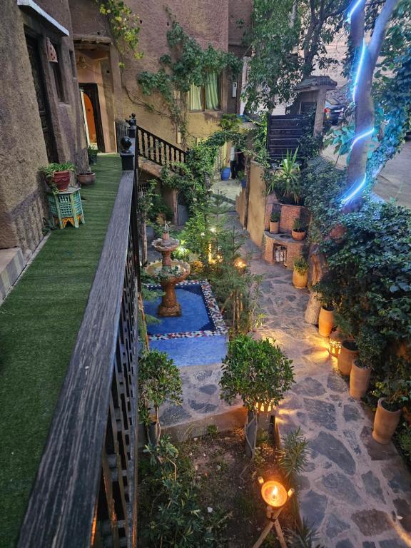 a courtyard with a garden with plants and lights at Riad Oussagou in Imlil