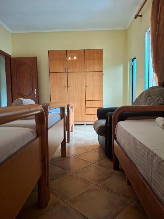 a room with two beds and a closet at GuestHouseMantho in Gjirokastër