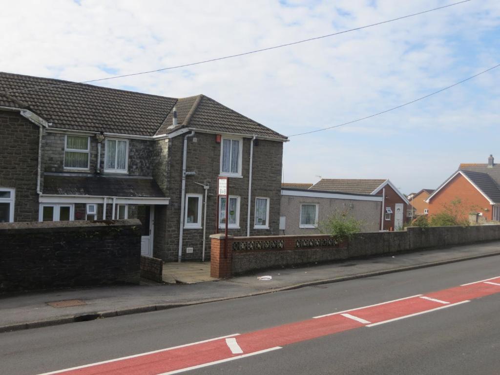 a row of houses on the side of a street at Four seasons Guest House in Pembrey