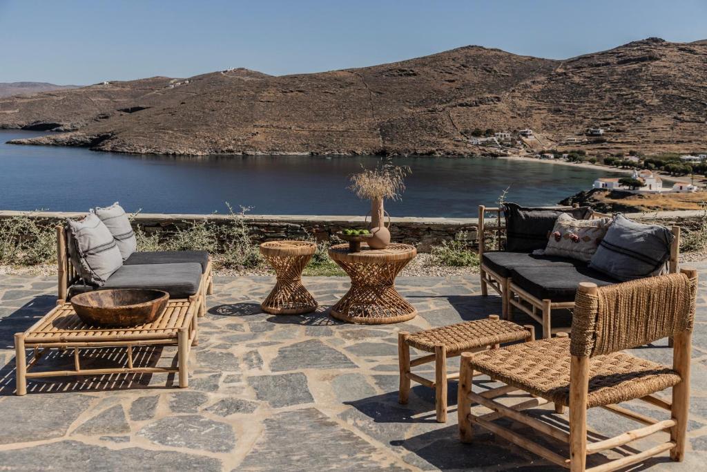 a patio with chairs and a view of a lake at Stimata in Kithnos
