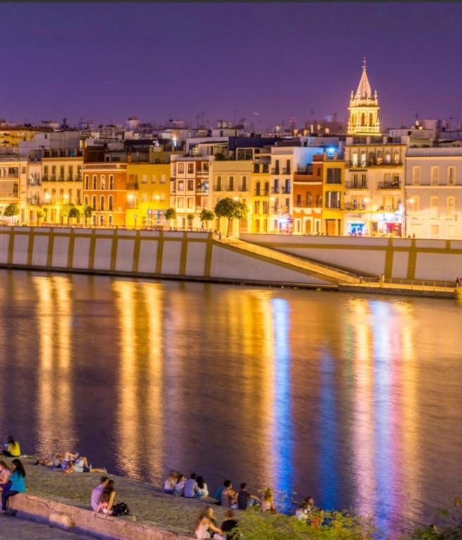 a view of a city at night at Ole triana in Seville