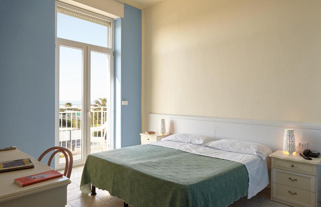 Postel nebo postele na pokoji v ubytování Hotel Mirage