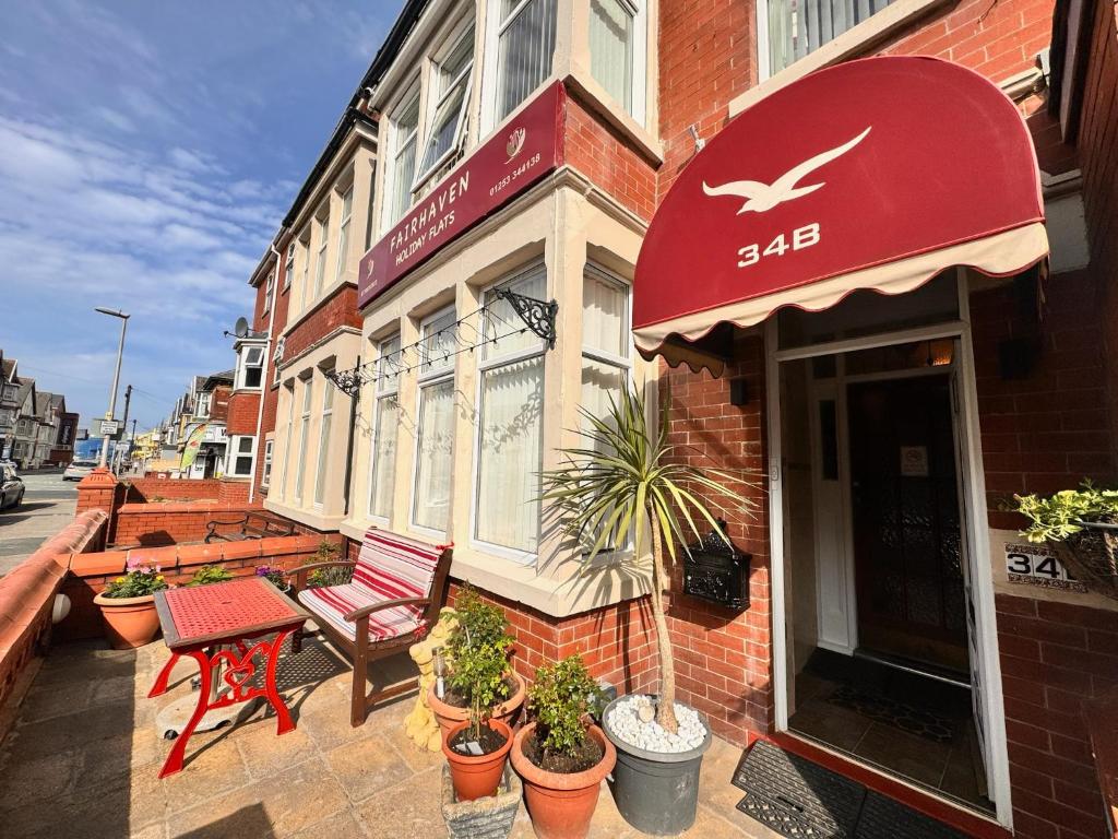 a building with a red sign on the side of it at Fairhaven Holiday Flats in Blackpool