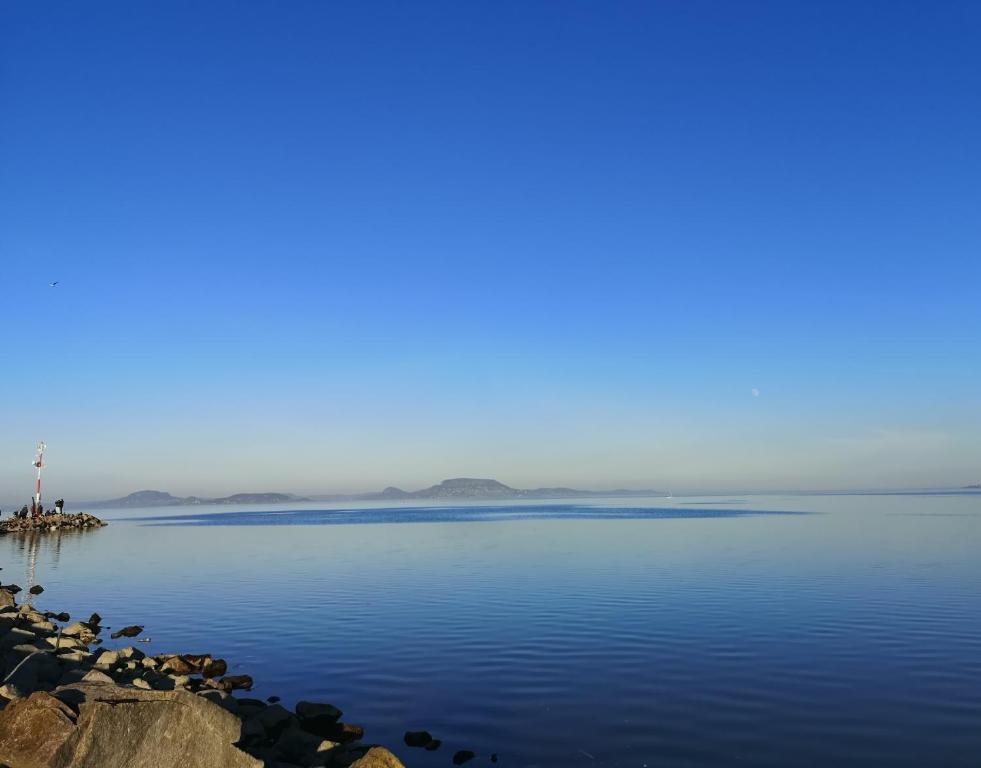 a view of a body of water with a lighthouse at Petőfi 4 in Balatonmáriafürdő