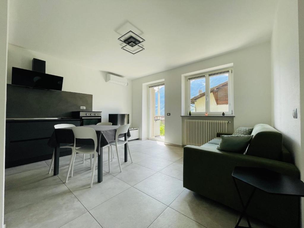 a living room with a couch and a table at Maison Syrah in Aosta