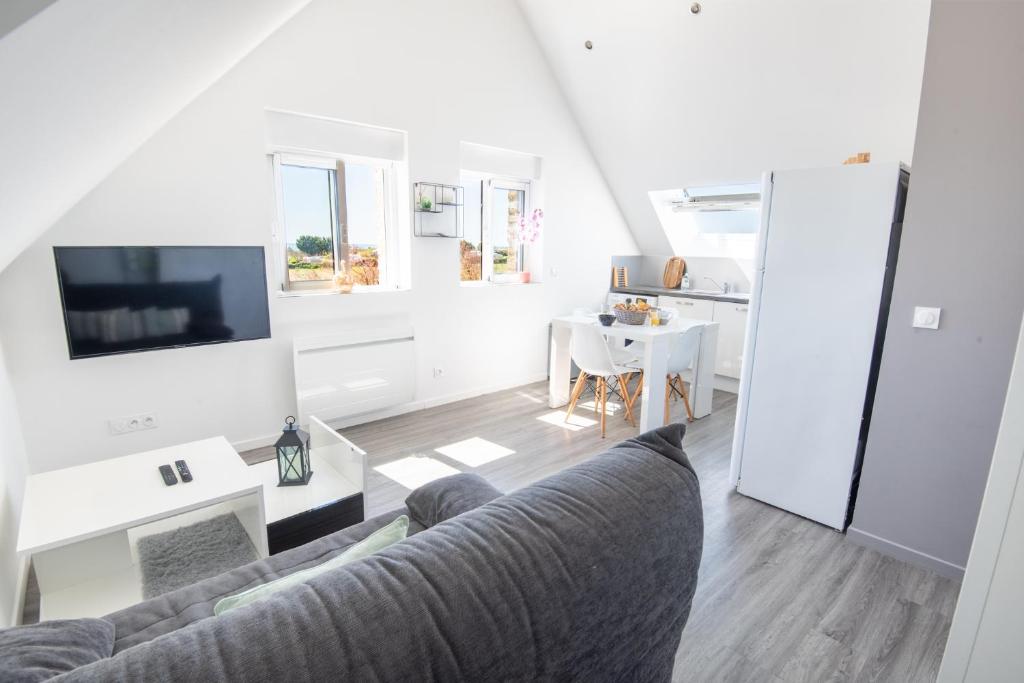 un salon avec un canapé et une table dans l'établissement Agréable et lumineux T3 entouré de nature à 500m de la plage par Groom, à Guidel