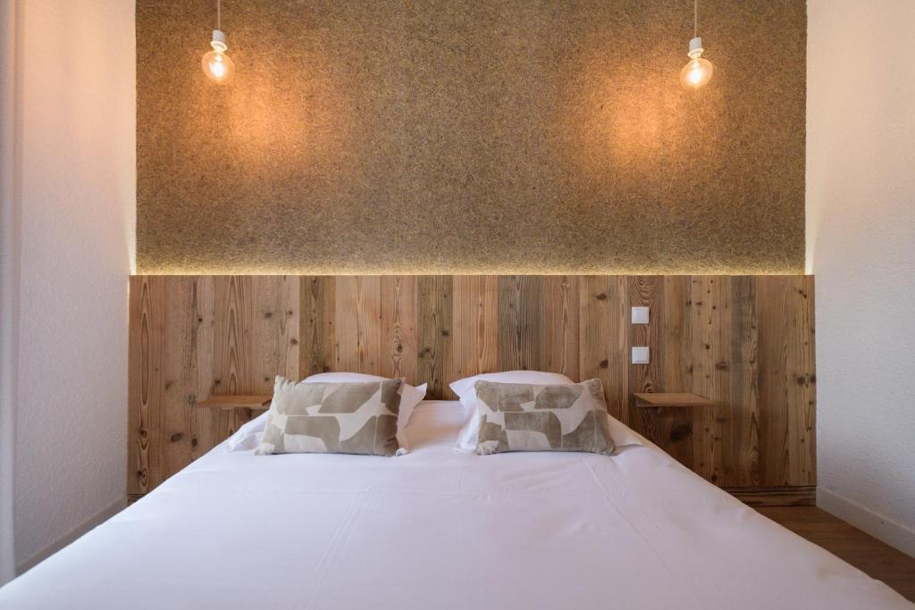 Postel nebo postele na pokoji v ubytování Hôtel Maison Doron
