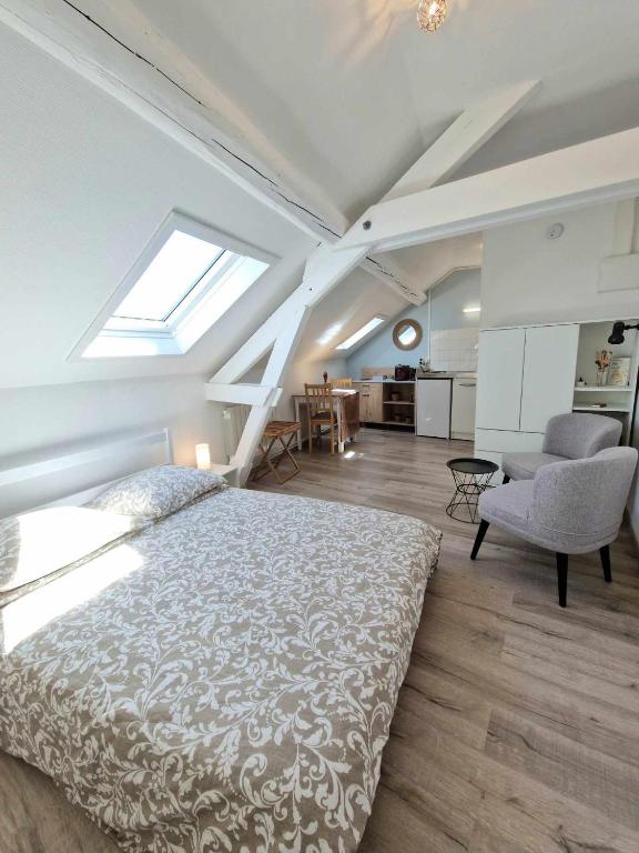 une chambre avec un lit, un canapé et une chaise dans l'établissement Chez Clovis - proche gare centre et arena, à Reims