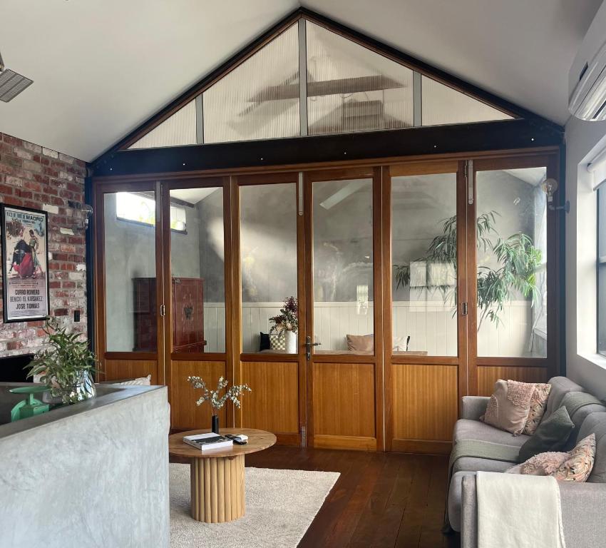 a living room with a large glass wall at T h e L o f t - Stunning private apartment in Perth