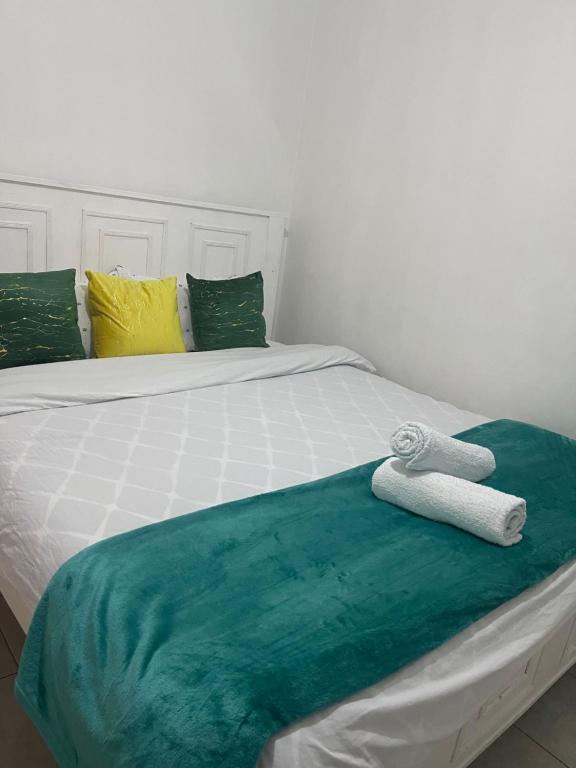 a bed with two towels sitting on top of it at Bella Homes Thika Town in Thika