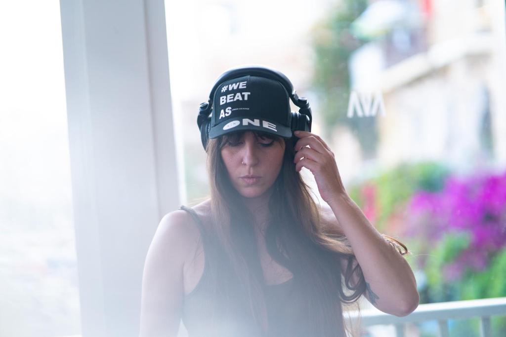 a woman wearing a hat with a time spent is needed at Cavalieri Art Hotel in St. Julianʼs