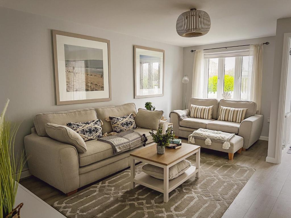 a living room with a couch and a table at Sunnyside in Camber