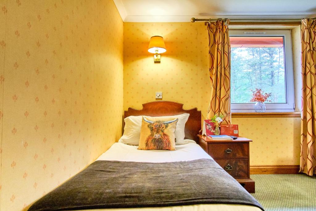 Postel nebo postele na pokoji v ubytování Muthu Ben Doran Hotel