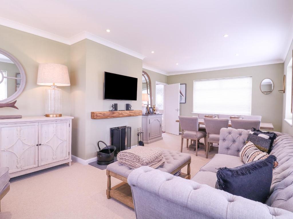 a living room with two couches and a dining room at The Farmhouse in Clacton-on-Sea