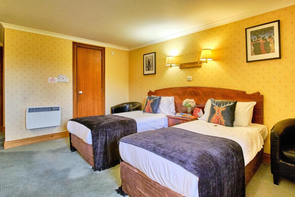 Postel nebo postele na pokoji v ubytování Muthu Ben Doran Hotel
