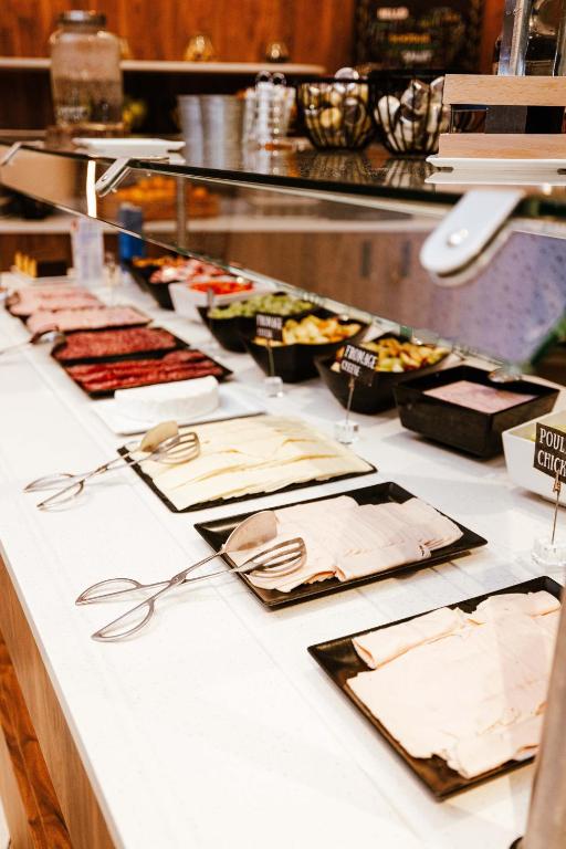 a buffet line with many different types of food at Ibis Luxembourg Airport in Luxembourg