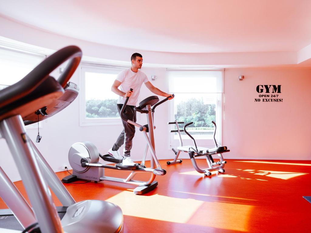 a man standing on a treadmill in a gym at Ibis Luxembourg Airport in Luxembourg