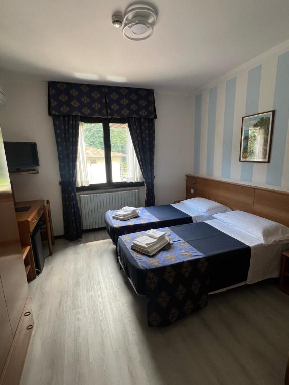 Postel nebo postele na pokoji v ubytování Hotel Merloni