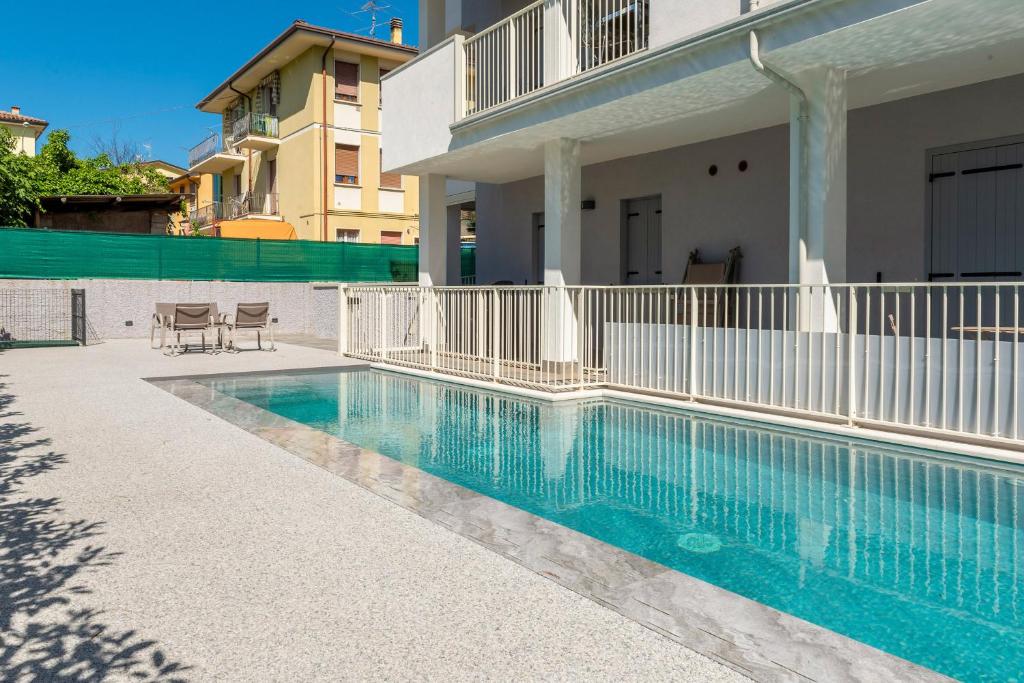 a swimming pool in front of a house at Panoramic Apartment Rudi in Garda