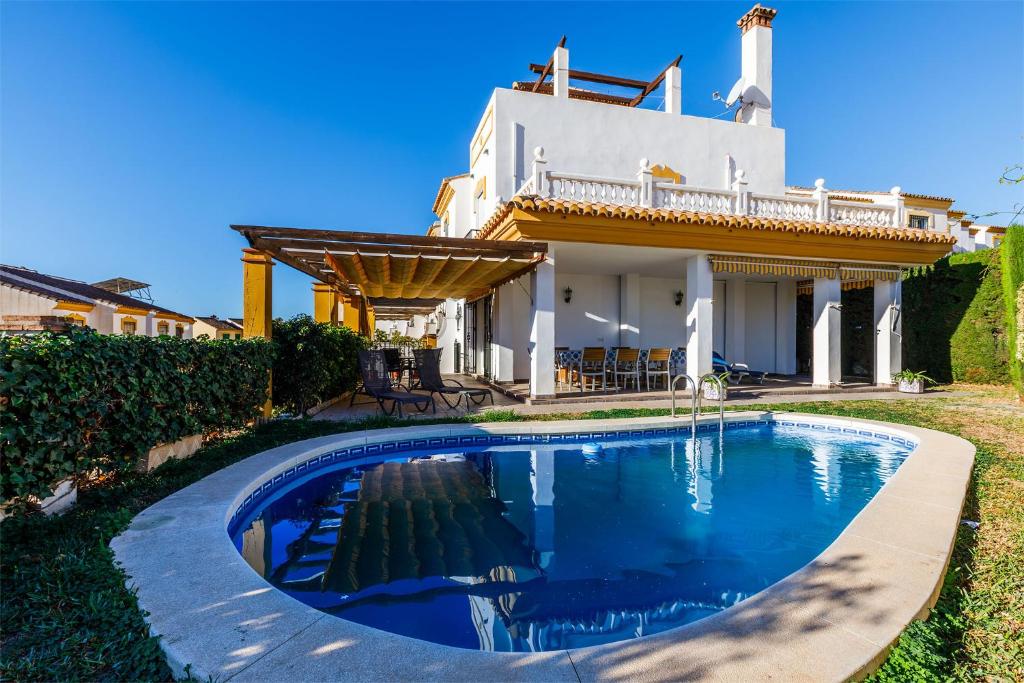 a swimming pool in front of a house at A&n Moriles, Torre del Mar in Torre del Mar