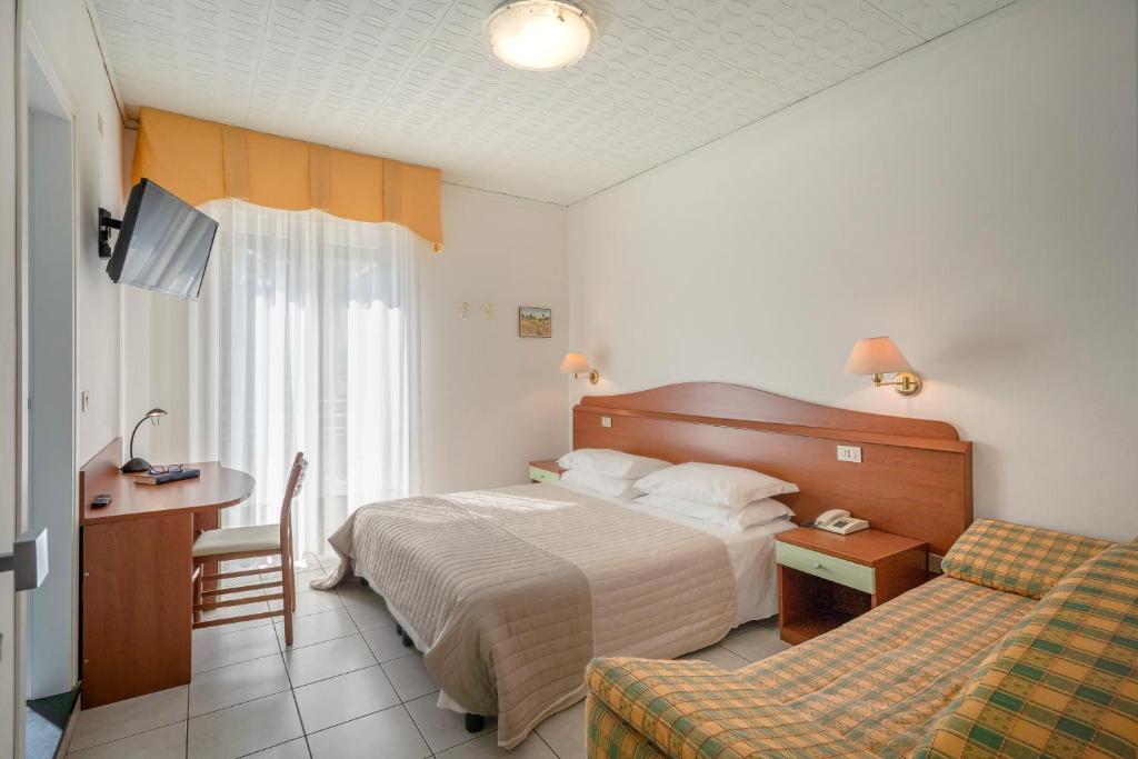 Postel nebo postele na pokoji v ubytování Hotel Miramare