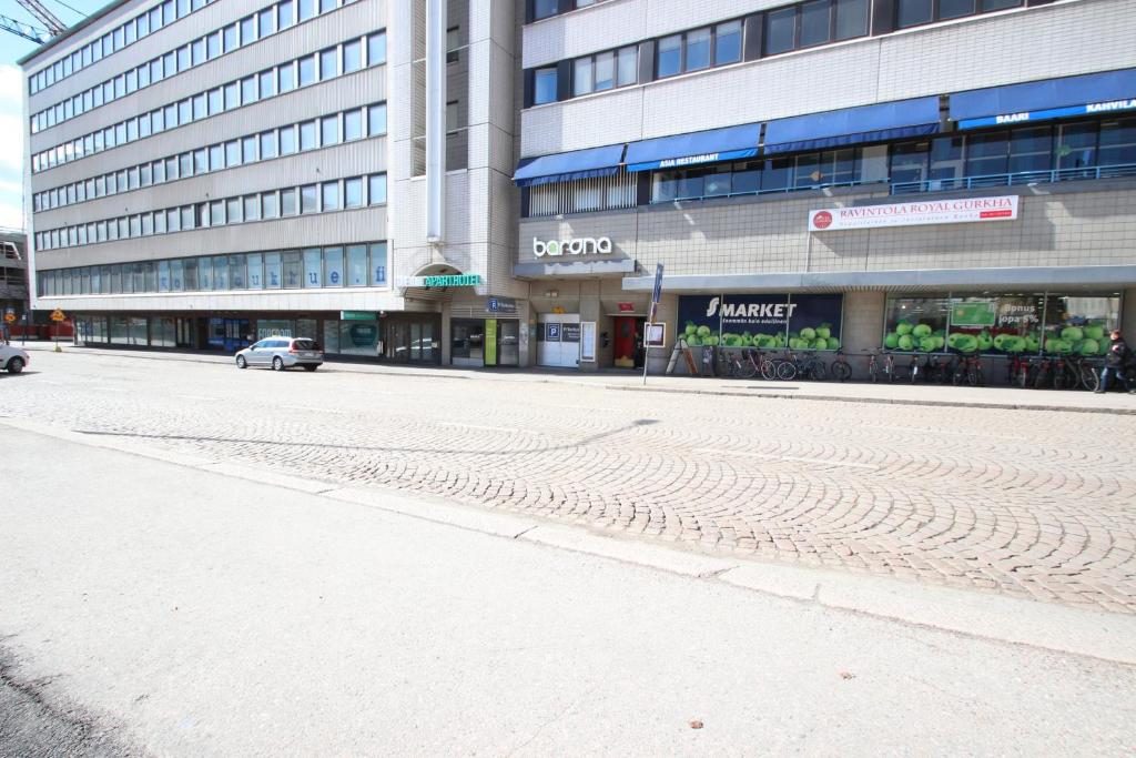 an empty street in front of a building at Forenom Apartments Rauhankatu 16 in Lahti