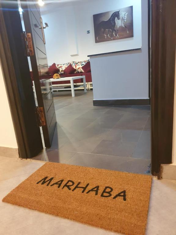 a welcome mat in front of a door at Appartement a saidia de 100m2 familiale in Saidia 