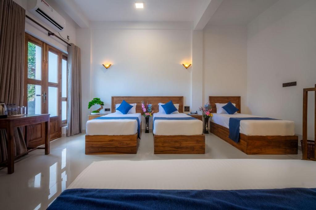 Postel nebo postele na pokoji v ubytování Hotel Alaskabay Arugambay