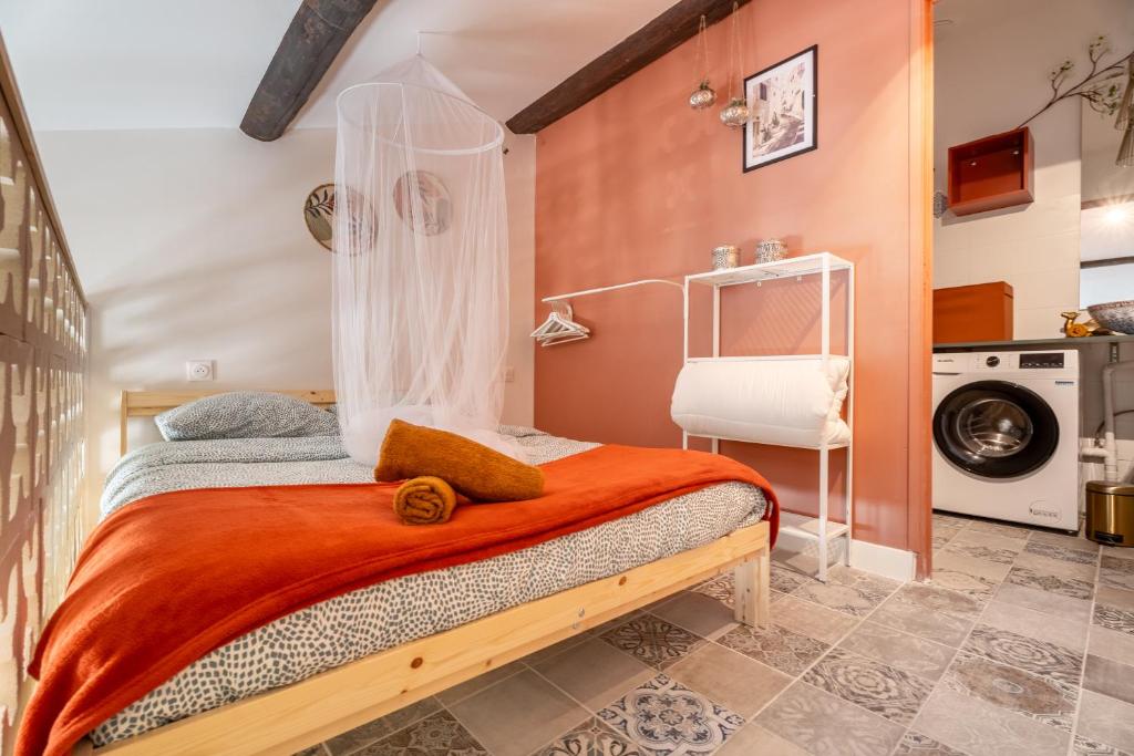 - une chambre avec un lit et un lave-linge dans l'établissement La Médina parfum d orient, à Marseille