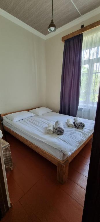 a bedroom with a large white bed with a window at Hooni_guesthouse in Odzun