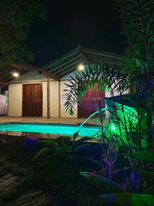 a house with a swimming pool at night at Villa Atlântic Icaraizinho 700 m da praia in Icaraí